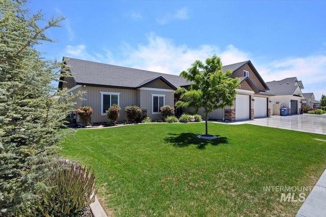 single story home with a garage and a front lawn