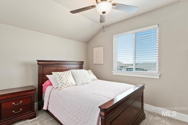 bedroom with ceiling fan, lofted ceiling, and light colored carpet