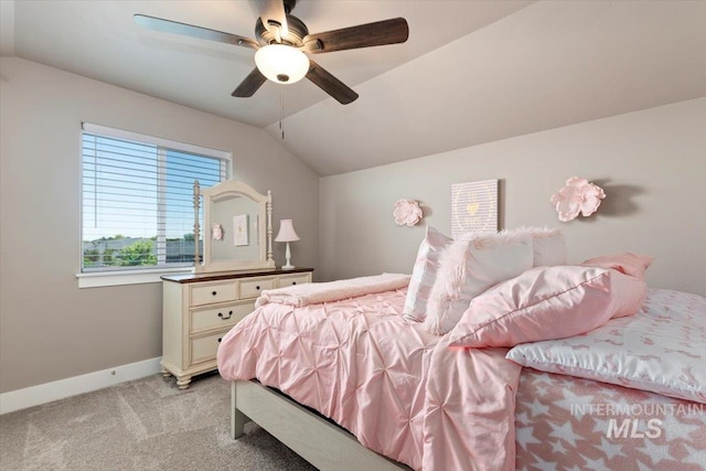 carpeted bedroom with vaulted ceiling and ceiling fan