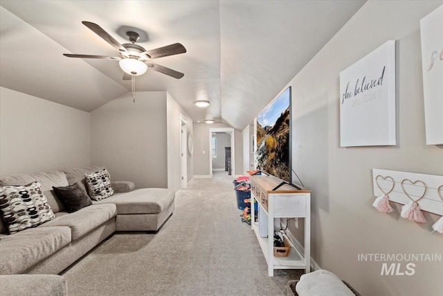 carpeted living room with ceiling fan and lofted ceiling