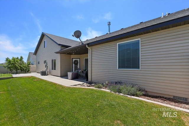 rear view of property featuring a patio area and a lawn