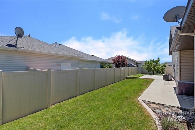 view of yard featuring central AC unit and a patio area