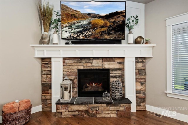 details with a fireplace and wood-type flooring