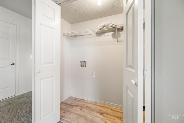 clothes washing area with a textured ceiling and washer hookup