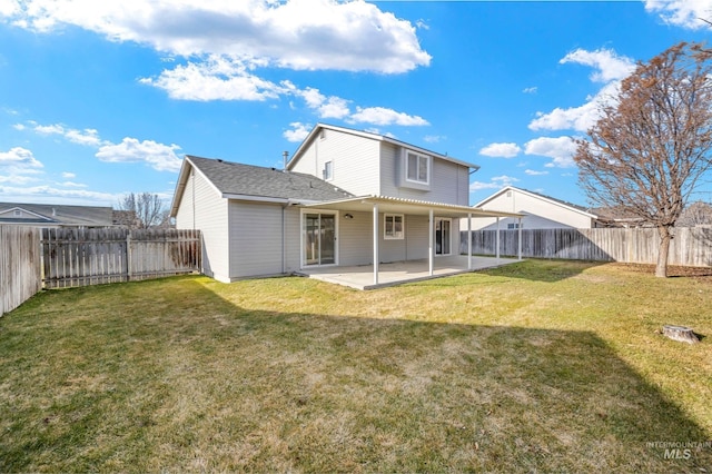 back of property featuring a lawn and a patio area