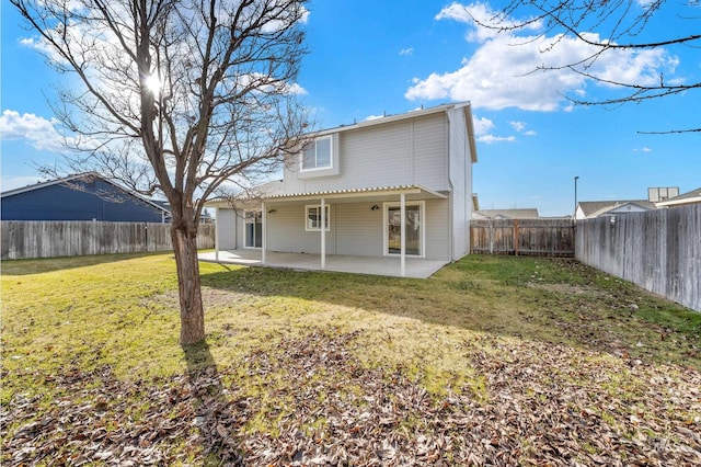 rear view of house featuring a yard and a patio area