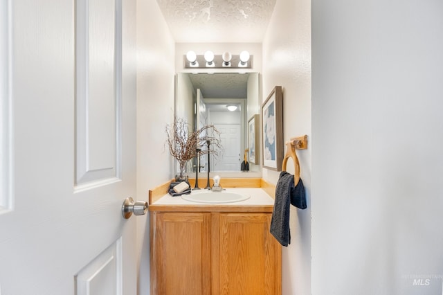 bathroom with a textured ceiling and vanity