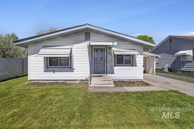 view of front of house with concrete driveway and a carport