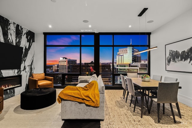 living room featuring a premium fireplace and a wall of windows