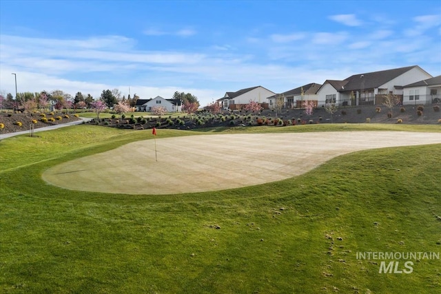 view of property's community with a yard