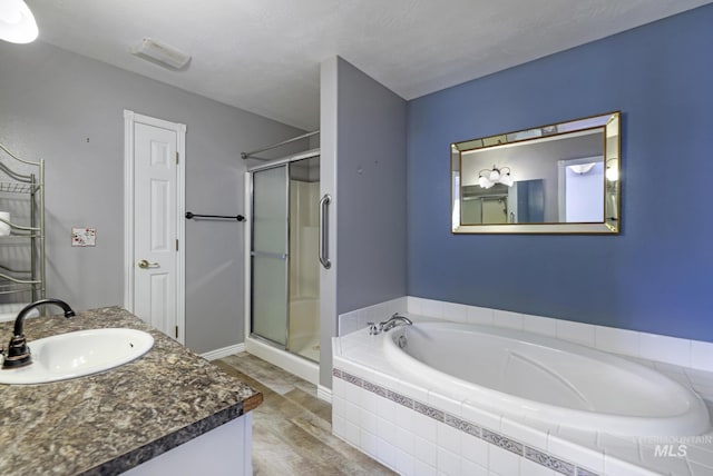 2563 Paintbrush Dr, Twin Falls, ID 83301 - bathroom with vanity, a bath, and a stall shower