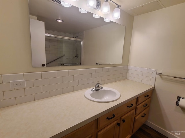 200 N 3rd Unit 401, Boise, ID 83702 - bathroom featuring a shower with shower door, decorative backsplash, and vanity