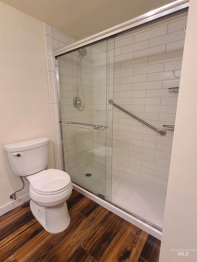200 N 3rd Unit 401, Boise, ID 83702 - bathroom with toilet, a shower stall, and wood finished floors
