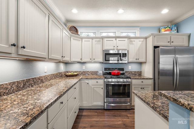 998 E Shadow Creek Ln, Eagle, ID 83616 - kitchen featuring stainless steel appliances, ornamental molding, dark wood finished floors, dark stone counters, and recessed lighting