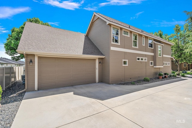 998 E Shadow Creek Ln, Eagle, ID 83616 - view of side of home with a garage, concrete driveway, fence, and roof with shingles