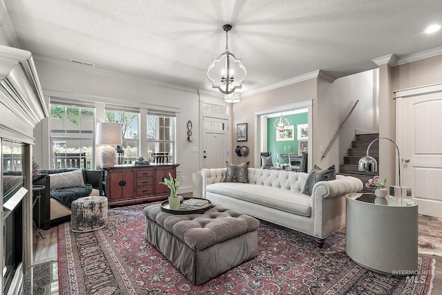 998 E Shadow Creek Ln, Eagle, ID 83616 - living room featuring a chandelier, stairway, ornamental molding, wood finished floors, and a textured ceiling