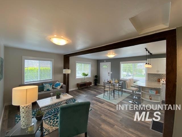 living area with wood finished floors and baseboards