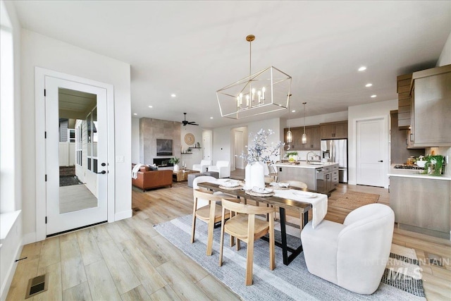 6356 S Cubola Way, Meridian, ID 83642 - dining room with a chandelier, recessed lighting, ceiling fan, and light wood-style flooring