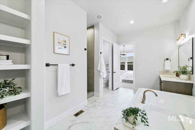 6356 S Cubola Way, Meridian, ID 83642 - ensuite bathroom with marble finish flooring, a bath, toilet, vanity, and baseboards