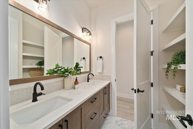 6356 S Cubola Way, Meridian, ID 83642 - bathroom featuring double vanity, marble finish flooring, baseboards, and backsplash