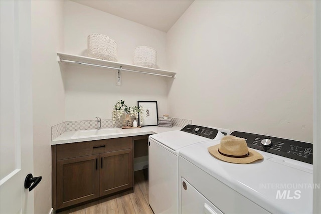 6356 S Cubola Way, Meridian, ID 83642 - laundry area featuring washer and clothes dryer, light wood-style floors, and cabinet space