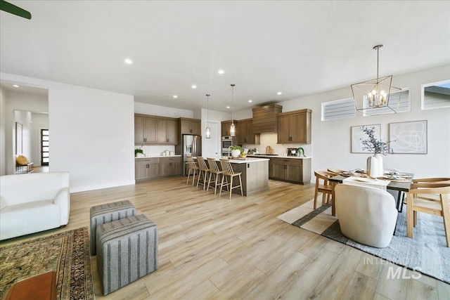 6356 S Cubola Way, Meridian, ID 83642 - dining area featuring light wood-style floors, a chandelier, recessed lighting, and baseboards