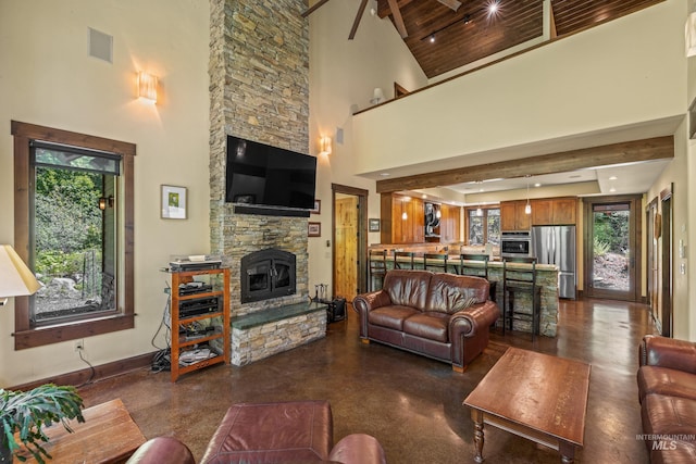 278 Elk Lake Rd, New Meadows, ID 83654 - living area with a towering ceiling, plenty of natural light, a stone fireplace, and beamed ceiling