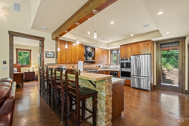 278 Elk Lake Rd, New Meadows, ID 83654 - kitchen with appliances with stainless steel finishes, a peninsula, finished concrete floors, tasteful backsplash, and recessed lighting