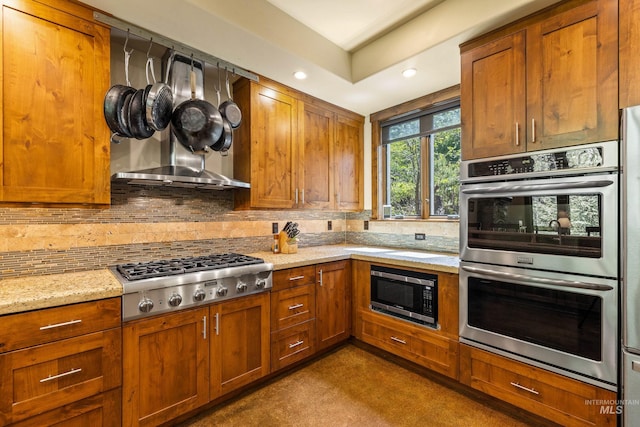 278 Elk Lake Rd, New Meadows, ID 83654 - kitchen featuring stainless steel appliances, decorative backsplash, brown cabinetry, and recessed lighting
