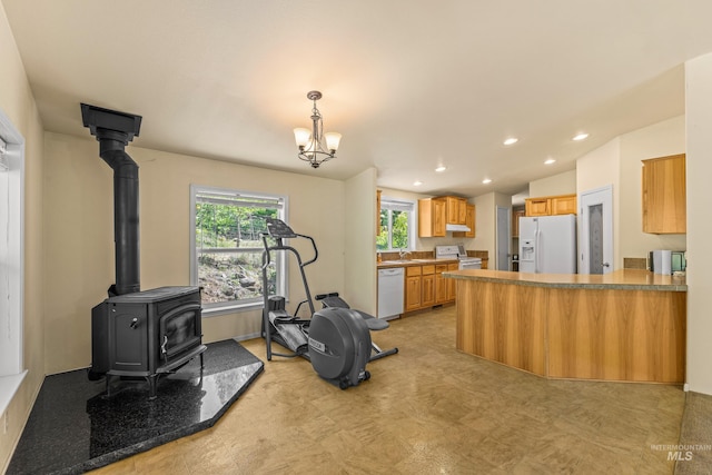 278 Elk Lake Rd, New Meadows, ID 83654 - workout area with recessed lighting, a wood stove, light flooring, and a chandelier
