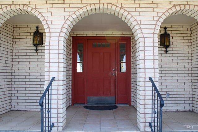 view of exterior entry featuring a porch