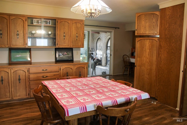 dining room with dark hardwood / wood-style floors and a chandelier