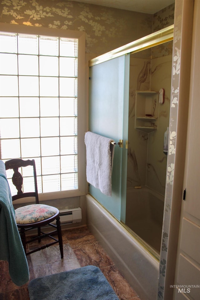 bathroom with combined bath / shower with glass door and a wealth of natural light