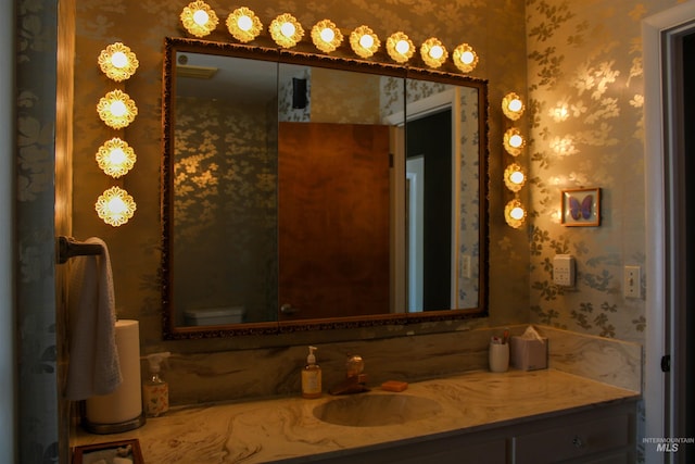 bathroom featuring vanity and toilet