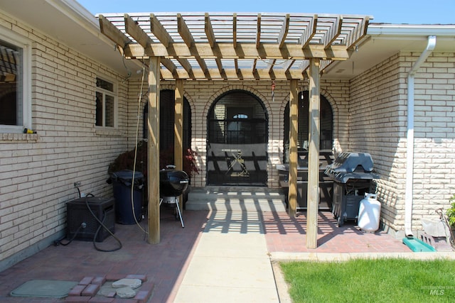 view of patio featuring a grill and a pergola