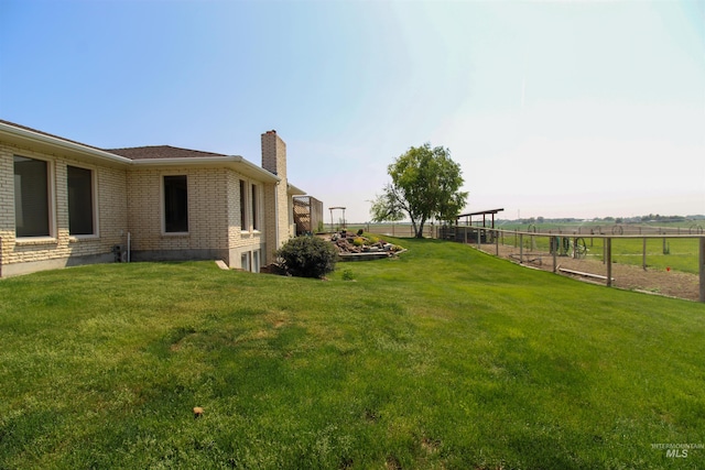 view of yard with a rural view