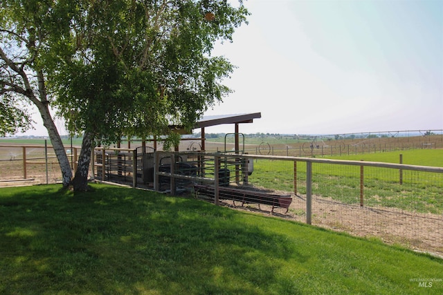 view of yard featuring an outbuilding and a rural view