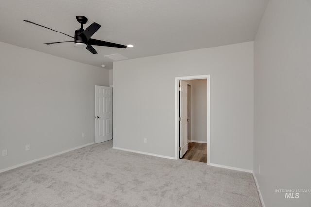 unfurnished bedroom featuring light carpet, ceiling fan, and baseboards