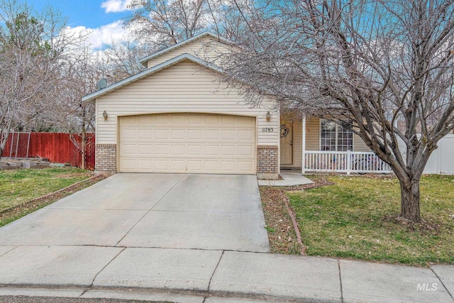 view of front of property with a front lawn, a porch, fence, concrete driveway, and brick siding