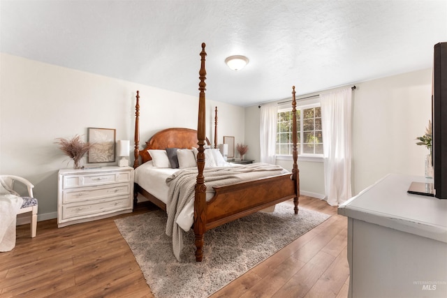 bedroom featuring light wood-style flooring and baseboards
