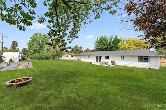 view of yard featuring a fire pit and a patio area