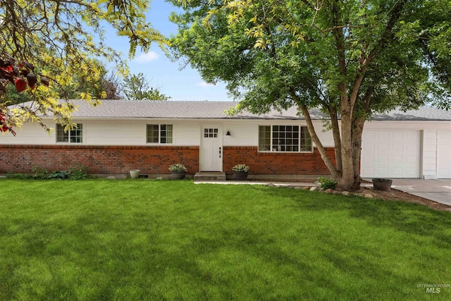 single story home featuring brick siding, a front lawn, an attached garage, and concrete driveway