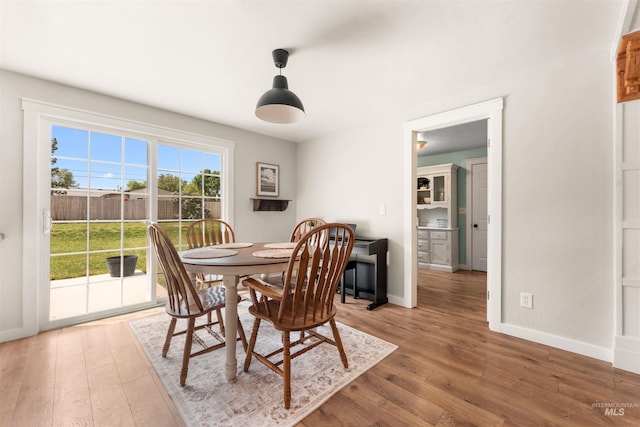 dining space with wood finished floors and baseboards