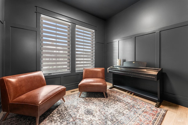 2664 N Yount Way, Eagle, ID 83616 - sitting room with a decorative wall, wood finished floors, and wainscoting