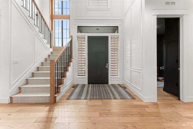 2664 N Yount Way, Eagle, ID 83616 - entrance foyer featuring a decorative wall, light wood-style floors, stairway, and baseboards