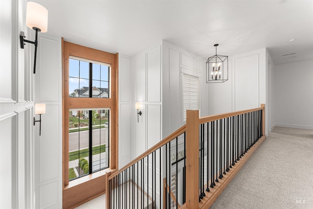 2664 N Yount Way, Eagle, ID 83616 - hallway with a chandelier, carpet flooring, an upstairs landing, and baseboards