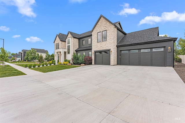 2664 N Yount Way, Eagle, ID 83616 - view of front of property featuring concrete driveway, a garage, a front lawn, stone siding, and roof with shingles
