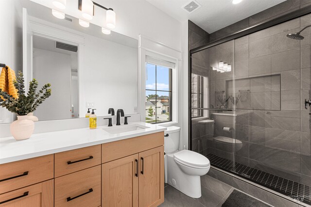 2664 N Yount Way, Eagle, ID 83616 - full bath featuring toilet, vanity, a stall shower, and tile patterned floors