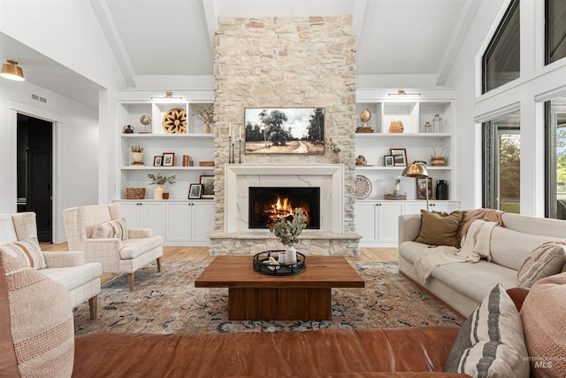 2664 N Yount Way, Eagle, ID 83616 - living area featuring built in features, a stone fireplace, and light wood-style floors
