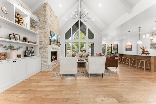 2664 N Yount Way, Eagle, ID 83616 - living room featuring a chandelier, beamed ceiling, light wood-style flooring, a stone fireplace, and high vaulted ceiling